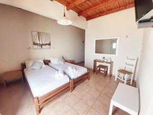a bedroom with a bed and a table in it at Agia Roumeli Hotel in Agia Roumeli