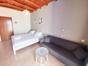 a living room with a couch and a table at Agia Roumeli Hotel in Agia Roumeli
