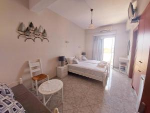 a bedroom with a bed and a table and a window at Agia Roumeli Hotel in Agia Roumeli