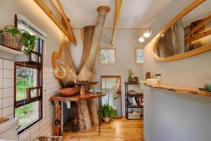 a kitchen with wooden floors and a vaulted ceiling at Elsewhere Treehouse and Apartment on the River in Muldersdrift