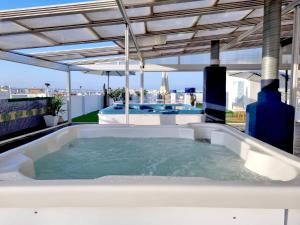 a hot tub on the roof of a house at Hotel Porto in Gandía