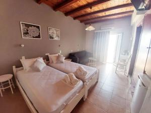 a bedroom with two beds with towels on them at Agia Roumeli Hotel in Agia Roumeli