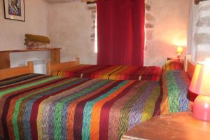 a hotel room with two beds and a window at Auberge de Lascours in Ceilhes-et-Rocozels