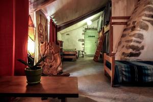 a room with a table and a bed and a door at Auberge de Lascours in Ceilhes-et-Rocozels