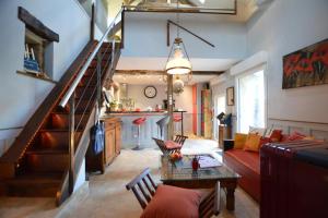 a living room with a staircase and a couch at La porcherie du pet en l'air in Saint Malo