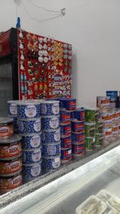 a pile of canned food on a counter in a store at White Hotel in K'obulet'i
