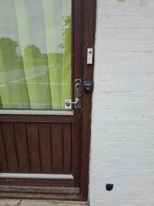 a wooden door with a window on a building at Rural in Assens +1 photo