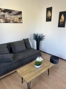 a living room with a couch and a coffee table at Apartment 2 - Haus Lausitzring in Annahütte