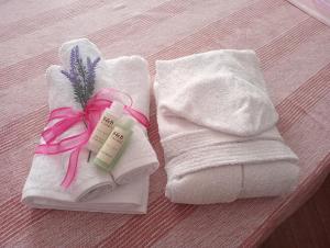 a pair of towels and a bottle of lotion and a book at B&B A TAVERNA in Lauria