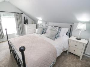 a bedroom with a large bed and a window at Branwen in Talacre