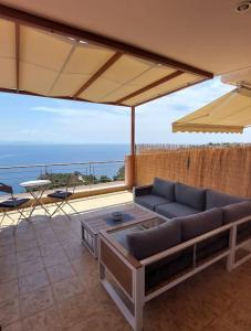 a living room with a couch and a table at Simply Meraki Gytheian apt with Panoramic Sea View in Gythio
