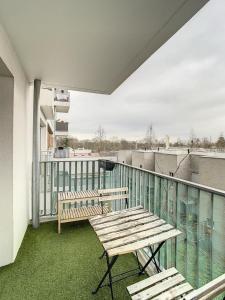 a wooden bench sitting on a balcony with a view at Grand Appart Renové centre ville Tram Paris 6pers in Épinay-sur-Seine