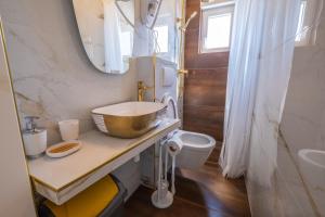 a bathroom with a bowl sink and a toilet at Premium Relax Rooms in Novi Vinodolski