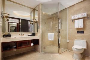 a bathroom with a shower and a toilet and a sink at Zhongshan Phoenix By Funyard in Zhongshan