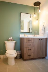 a bathroom with a toilet and a sink and a mirror at 90 San Luis Street Unit D in Avila Beach