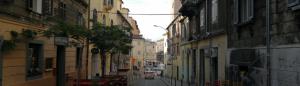 an alley with buildings and a car driving down a street at Unique city center Apartments Gran Fenice with free garage parking and roof terrace in one of the apartments in Rijeka