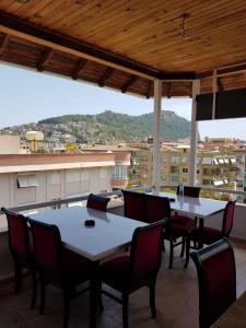 a patio with tables and chairs and a view of a city at Alanya Luxury apart in Alanya