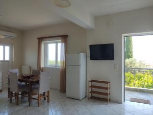 a dining room with a table and a refrigerator at Ntina's apartment in Aigio