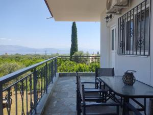 a patio with a table and chairs on a balcony at Ntina's apartment in Aigio