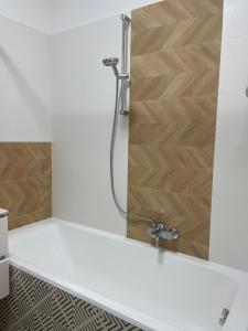 a bathroom with a shower with a glass door at Neighbor of Gellért Spa by NW in Budapest