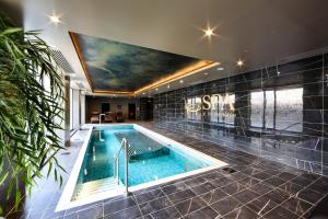 a swimming pool in a house with a painting on the ceiling at The Ebrington Hotel in Derry Londonderry