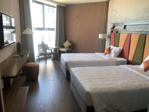 Postel nebo postele na pokoji v ubytování APEC MŨI NÉ MANDALA