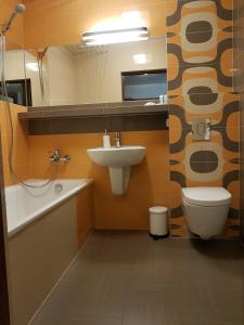 a bathroom with a sink and a toilet at Wigilijna Apartament in Lublin