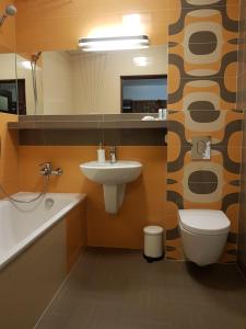 a bathroom with a sink and a toilet and a mirror at Wigilijna Apartament in Lublin