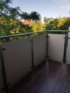 a balcony with a view of trees in the background at Wigilijna Apartament in Lublin
