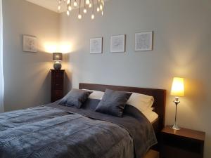 a bedroom with a bed with two pillows on it at Wigilijna Apartament in Lublin