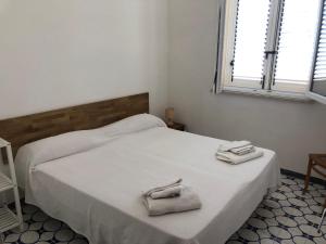 a bedroom with a bed with two towels on it at Villa Panoramica in Valderice