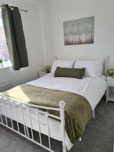 a bedroom with a bed with a white bed frame at Ria's B n B in Pocklington