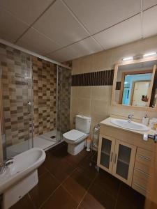 a bathroom with a toilet and a sink and a shower at Magnifico Paradis Village in Salou