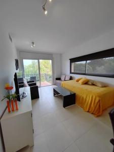 a bedroom with a bed with a yellow bedspread at Magnifico Paradis Village in Salou