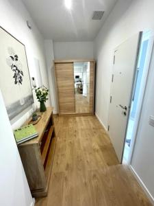 a room with a hallway with a wooden floor at GATU PREMIUM Las Caracolas, Aire C, parking y wifi in El Puerto de Santa María