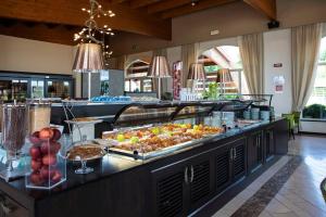 a buffet line with many different types of food at Lake Garda Resort in Moniga