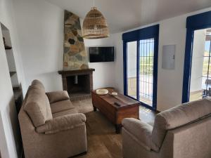 a living room with two couches and a fireplace at VILLA GABRIEL in Canillas de Albaida