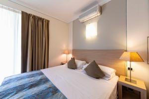 a hotel room with a bed and a window at Lake Garda Resort in Moniga +50 photos
