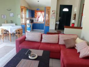 弗魯卡斯岩的住宿－Private relaxation holiday home in Halkidiki，客厅配有红色的沙发和桌子