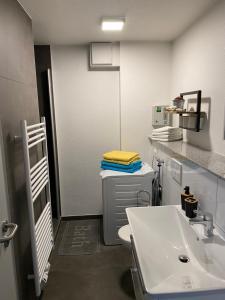 a bathroom with a toilet and a sink at Naturnahe schöne neu gestaltete Ferienwohnung in Würselen +38 photos