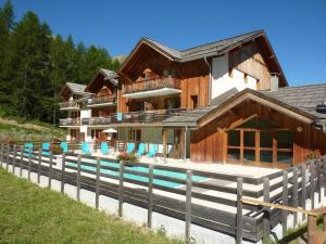 a large house with a pool in front of it at Appartement Les Orres, 2 pièces, 4 personnes - FR-1-322-38 in Les Orres