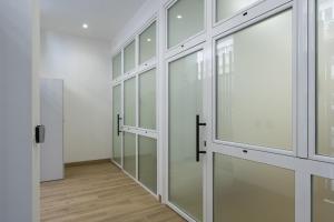 a row of glass doors in a room at Apartamentos Mª Luisa de Dios Nº7 in Granada