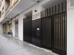 a row of black doors on a building at Apartamentos Mª Luisa de Dios Nº7 in Granada