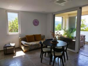 a living room with a table and a couch at M&D appartments in Komiža
