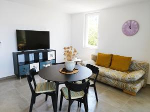 a living room with a table and a couch at M&D appartments in Komiža