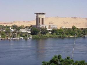 a view of a river with a building in the background at Memnon Hotel in Aswan