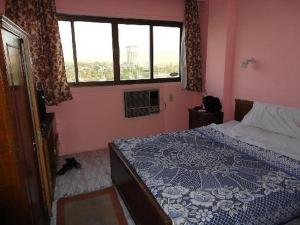 a small bedroom with a bed and a window at Memnon Hotel in Aswan