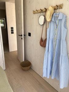 a blue dress hanging on a wall in a room at BUQEZ ECO RESORT - Beach Villas 2 and 8 - Seaview, new wifi! in Drage