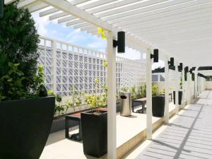 a white pergola on a patio with potted plants at WingsNest Cameron Town Night Market High Speed Wi-Fi in Tanah Rata