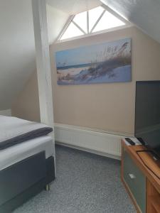 威廉港的住宿－FEWO am Dele Park，一间卧室设有一张床、一个窗口和一台电视。
